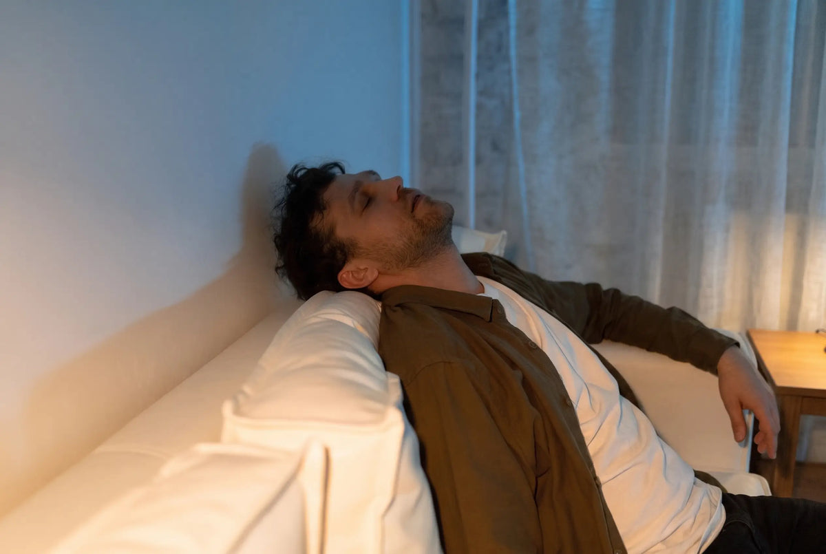 Man asleep on the sofa after a long day